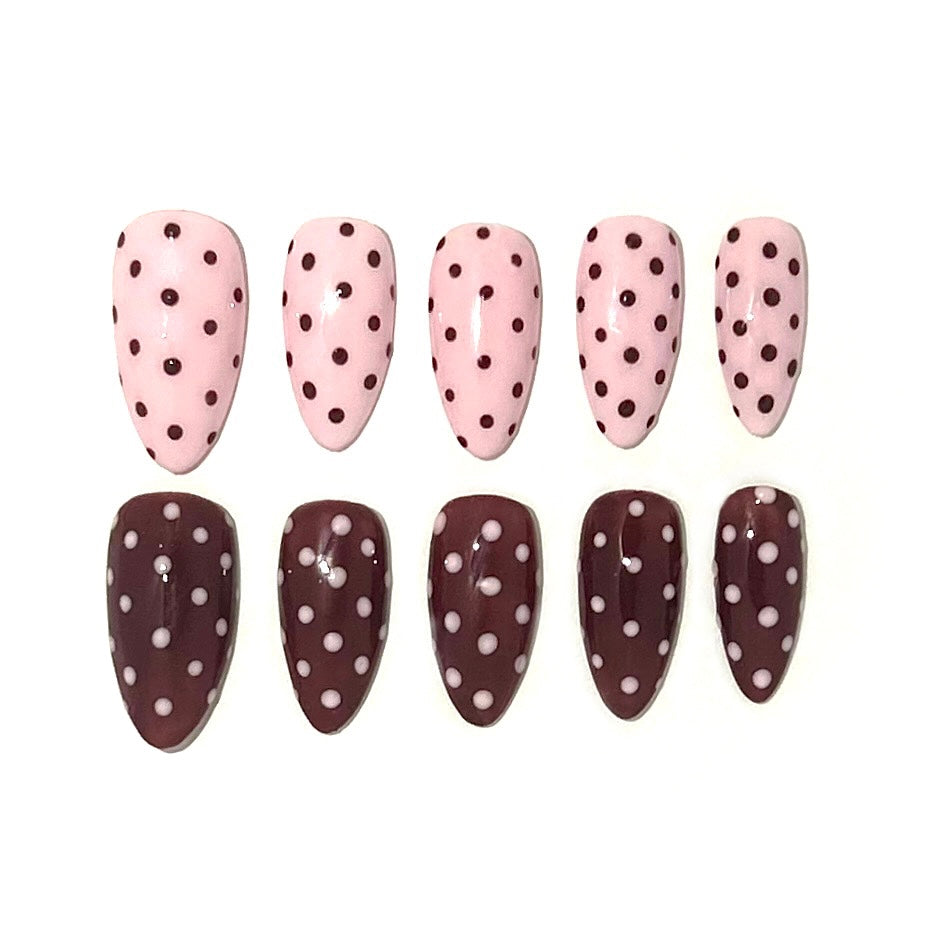 Left hand pink with brown polka dots and right hand brown with pink polka dots. This set is a almond medium.